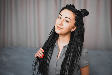 Portrait of a beautiful cool girl with Senegalese pigtails twists very cool
