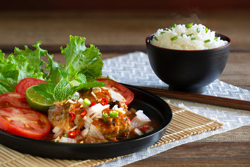 Spicy fish Canned Sardines Salad in black color dish and rice in black bowl (Thai food) but arrange dishes style Japanese