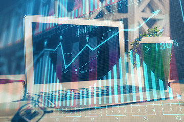 Financial graph colorful drawing and table with computer on background. Double exposure. Concept of...