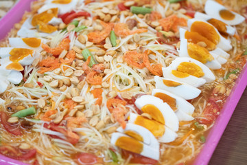 Somtum That was papaya spicy salad with salted egg on tray