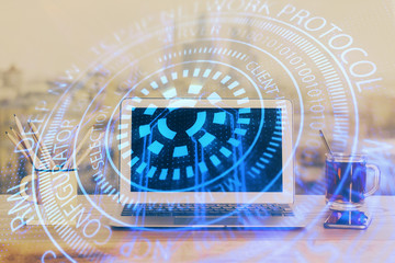 Double exposure of laptop computer and technology theme hologram. Concept of freelance work.