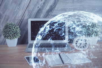 Computer on desktop with social network hologram. Multi exposure. Concept of international people connections.