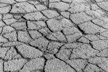 Texture of gray cracked asphalt. Abstract backdrop for design.