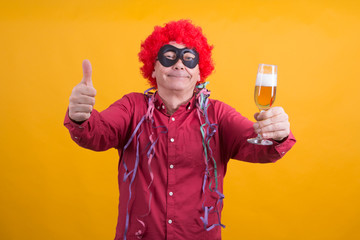 man with wig and streamers drinking funny and doing ok symbol, party concept