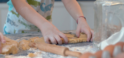 Obraz na płótnie Canvas Boy making cookies with a cookie cutter