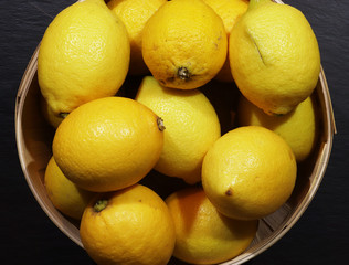 Photography of lemons in a wooden basket for food background