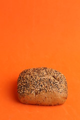 delicious bread rolls on colored background
