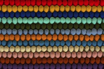 Texture of warm multi-colored woolen rug, background. Bee honeycombs. Color Trends 2020.