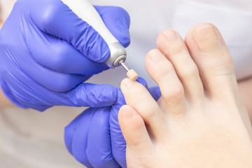 Therapeutic pedicure. Master podologist does hardware pedicure. visit to the podiatry. Foot treatment in the spa. Clinic of Podiatria.