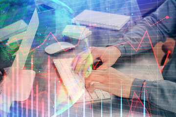 Stock graph with businessman typing on computer in office on background. Concept of analysis. Double exposure.