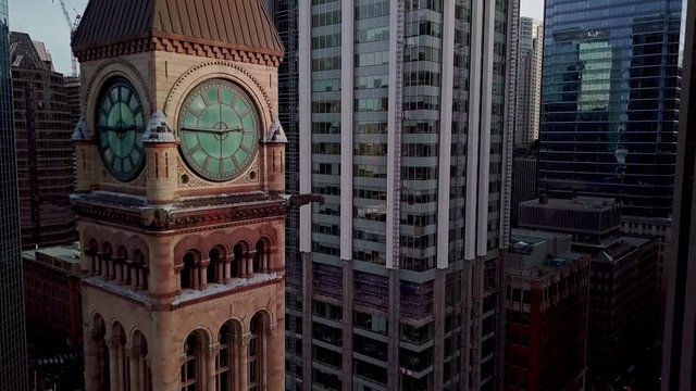 The Iconic Old City Hall Clock Tower At Nathan Phillips Square In Toronto, Canada Surrounded By High-Rise Modern Building Structures - Aerial Drone Shot