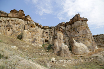 Fototapeta premium Unusual stones from volcanic rocks in the Red Valley near the village of Chavushin in the Cappadocia region in Turkey.