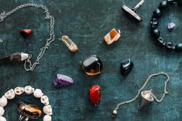 Magic flat lay. Various precious and semiprecious stones on a blue background for witchcraft.