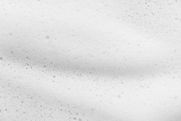 White cleanser foam texture background. Soap, shampoo bubbles closeup. Foamy skin care product sample
