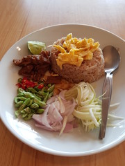 Closeup of rice fried with shrimp paste wooden background.