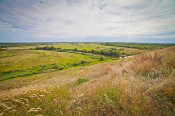 Fototapeta premium summer landscape with large meadows and blue sky and open space