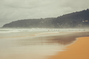 Phuket, Thailand - July 20, 2019: Kata beach in summer in cloudy weather, rainy season