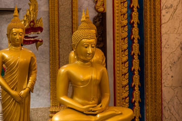 Wat Chalong, Phuket, Thailand - July 20, 2019: Hall of initiation Wat Chalong or Wat Chantharam. Gold Buddha Statue.