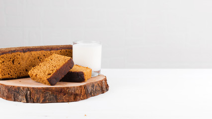 Traditional spice gingerbread cake with honey, ginger, cinnamon, nutmeg and annis from Holland with a glass of milk