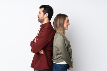 Couple in Valentine Day over isolated background keeping arms crossed