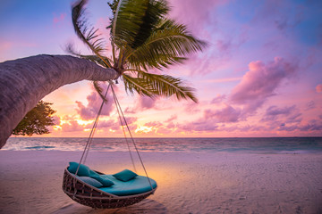 Tropical sunset beach background as summer landscape panorama with beach swing or hammock and white...