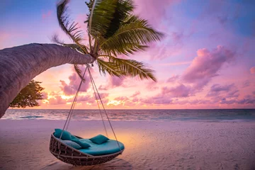  Tropical sunset beach background as summer landscape panorama with beach swing or hammock and white sand and calm sea beach banner. Perfect beach scene vacation or summer holiday concept © icemanphotos