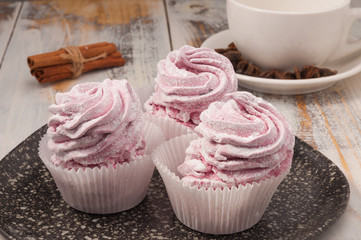 pink marshmallow sweet cake on a dark plate