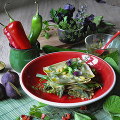 food photography of vegetarian dish, homemade pasta fazzoletti with pesto sauce and vegetable green...