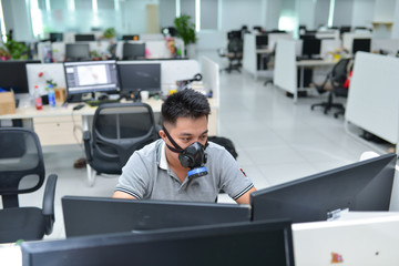 Fototapeta premium Office workers wear respirators/ gas masks instead of medical masks, the disease caused by coronavirus nCoV/Covid-19 has caused scarcity of medical equipment