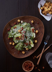 Caesar salad thai style with bacon serve with biscuits.