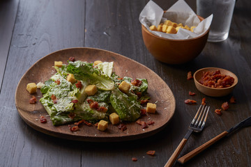 Caesar salad thai style with bacon serve with biscuits.