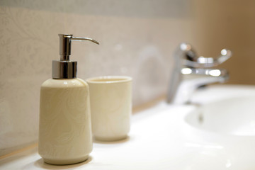 Soap bottle in luxury bath at the sink in the bathroom. Liquid soap bottle on the bathtub in modern bathroom. Bright inerior at the shower. space for text. Bathroom interior element