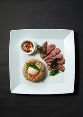 Fried rice with grilled steak house basil topping with onsen egg