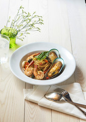 Thai basil spicy spaghetti seafood in white vintage tone.