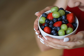 White plate with blueberry , green grape and strawberry. Healthy lifestyle. Fruit vitamin.