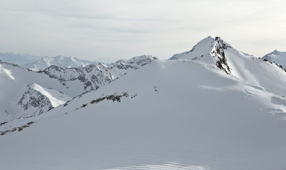 Fototapeta na wymiar Mountains in Austria in the Alps of Tyrol. Alpine winter landscape in Europe. Glacier Stubaier Gletscher. Deep snow