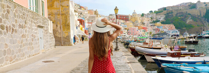 Holidays in Italy. Panoramic banner view of beautiful girl in stunning colorful harbor of Procida...