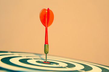 Close up red color arrow in the center of Bullseye or bull's-eye for business targeting and good...