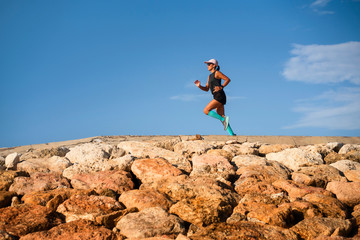 Fototapeta premium outdoors fitness lifestyle portrait of young attractive and athletic woman in compression running socks jogging happy on city park doing intervals workout in athlete training