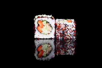 roll with vegetables and sesame seeds on a black isolated background with a reflection