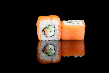California roll on a black isolated background with a reflection