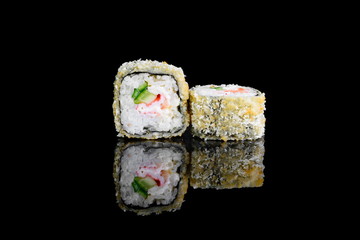 tempura roll with salmon on a black background with insulation and reflection