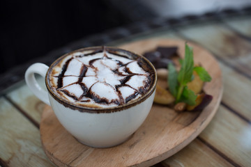 cup of coffee and nuts on wood table
