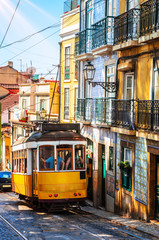 Naklejka na ściany i meble Famous vintage tram in the street of Alfama, Lisbon, Portugal