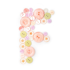 Letter F from pink and green buttons isolated on white background. Sewing kit. Colorful buttons, stylish alphabet for handmaking hobby. Handmade sew abc. Text from buttons