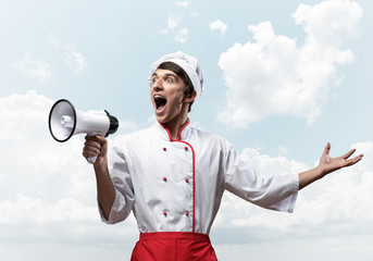 Young chef shouting loudly into megaphone