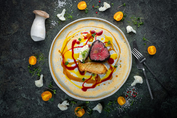 Tenderloin Beef steak with mushrooms and vegetables on a plate, food styling for serving in a...