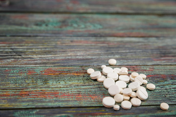 White pill on a wooden background