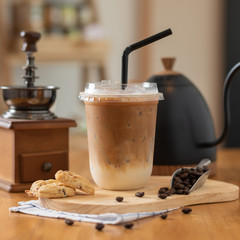 Iced coffee in plastic mugs on a wooden table