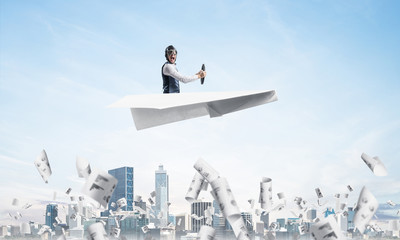 Screaming pilot sitting in paper plane